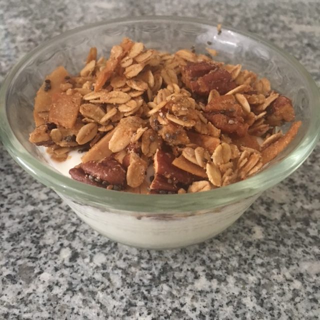 granola over yogurt in cup