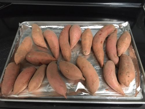 uncooked sweet potatoes on tray
