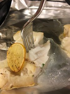 Broiled cod with lemon-olive-caper sauce- flaked fish